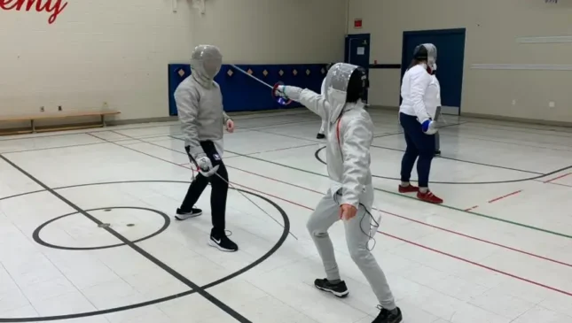 Two people fencing sabre